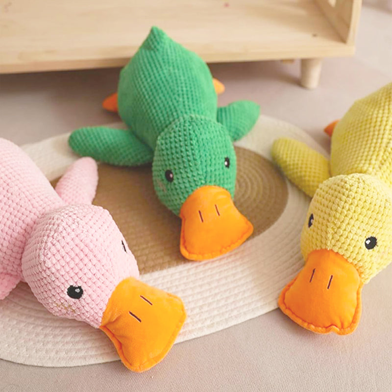Three FLOPPY FISH™ plush duck dog toys in pastel green, pink, and yellow displayed on light surface – cute calming squeaky ducks for playful pets