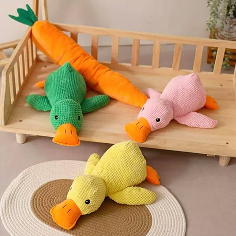 Colorful trio of knitted FLOPPY FISH™ duck dog toys in pink, green, and yellow displayed on a shelf – bite resistant plush toys for puppies and small dogs