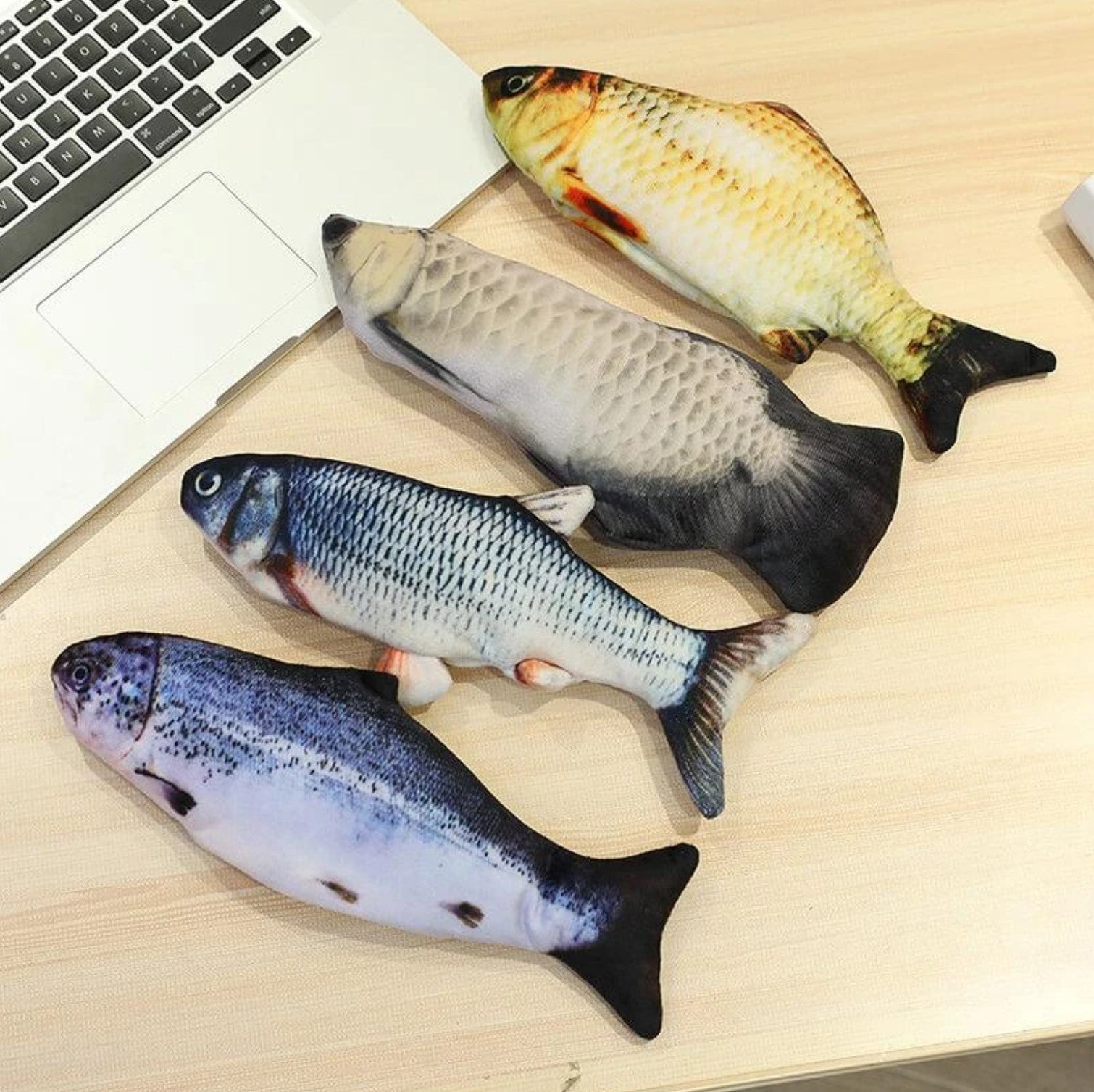 Four Different Floppy Fishy Flopping Cat Toys On Table